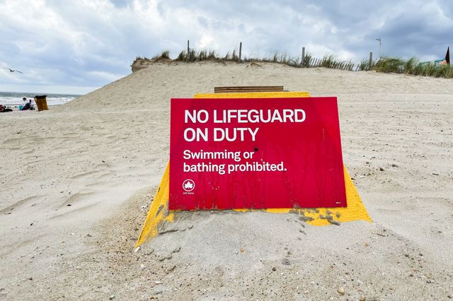 A sign that reads, "no lifeguard on duty" is placed in Rockaway Beach during Labor Day Weekend on September 5th, 2021.